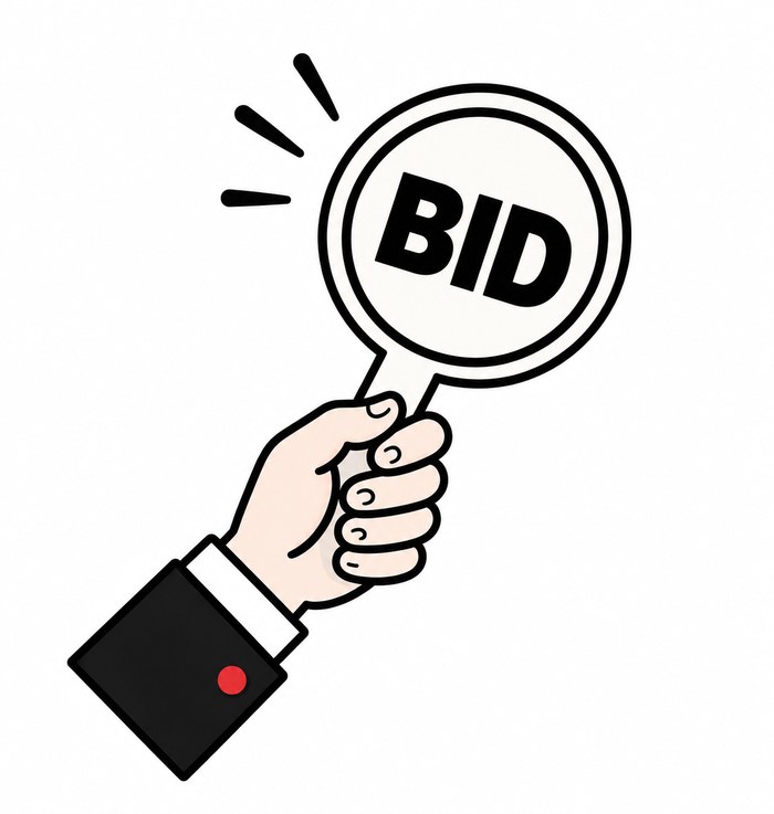 A hand holding up a BID paddle